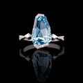 Beautiful white gold ring with diamonds and aquamarine on a black background Royalty Free Stock Photo