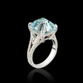 Beautiful white gold ring with diamonds and aquamarine on a black background Royalty Free Stock Photo