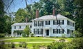 Beautiful white house with green trees and lawn in New England, Massachusetts Royalty Free Stock Photo