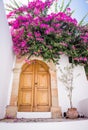 White house with pink flowers and big wooden door in Lindos, Rhodes, Greece Royalty Free Stock Photo