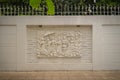 Beautiful white Java stucco patterned on the boundary wall. Vintage white wall bas-relief stucco in plaster, depicts Lotus flower Royalty Free Stock Photo