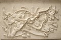 Beautiful white Java stucco patterned on the boundary wall. Vintage white wall bas-relief stucco in plaster, depicts Lotus flower Royalty Free Stock Photo