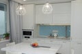 Beautiful white kitchen. Modern style. The decor of the apartment. Solid wood kitchen. Modern kitchen filling. Russia, Saint