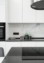 Beautiful white kitchen in new luxury home. Close-up countertop with induction hob Royalty Free Stock Photo