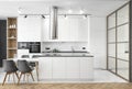 Beautiful white kitchen in new luxury home. Features island, pendant lights, hardwood floors, and square glass wall. Royalty Free Stock Photo