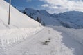 Beautiful white landscape, high mountains Swiss Alps, wide alpine winter road cleared, large snowdrifts on the side, Healthy