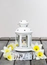 Beautiful white lantern with burning candle inside Royalty Free Stock Photo