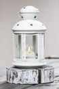 Beautiful white lantern with burning candle inside Royalty Free Stock Photo