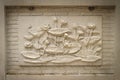 Beautiful white lotus stucco patterned on the boundary wall. Vintage white wall bas-relief stucco in plaster, depicts Lotus Royalty Free Stock Photo