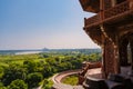 beautiful white marble Taj Mahal is seen from the Red Fort . In the foreground are green fields, a river, blue sky. Royalty Free Stock Photo