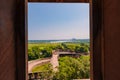 beautiful white marble Taj Mahal is seen from the Red Fort . In the foreground are green fields, a river, blue sky. Royalty Free Stock Photo