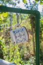 Beautiful White Metal Mug With Blue Decorations Hanging On The Pipes Of Outdoor Sink In The Garden