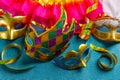 Beautiful white and multicolor carnival masks on a blue background. Purim, Mardi Gras. Top view Royalty Free Stock Photo