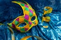 Beautiful white and multicolor carnival masks on a blue background. Purim, Mardi Gras. Top view Royalty Free Stock Photo