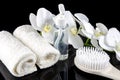 Beautiful white orchid , white towel and massage brush on black background Royalty Free Stock Photo