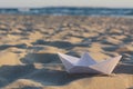 Beautiful white paper boat on sand outdoors, space for text Royalty Free Stock Photo