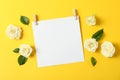 Beautiful white roses and blank sheet on yellow background Royalty Free Stock Photo