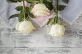 Beautiful white roses on white silk as wedding background Royalty Free Stock Photo