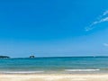 Beautiful white sand beach and clam ocean waves with clear blue sky in summer Royalty Free Stock Photo