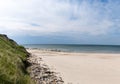 Beautiful white sand beach with high grassy sand dunes behind