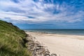 Beautiful white sand beach with high grassy sand dunes behind