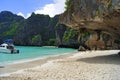 Beautiful white sandy beach beside the blue ocean surrounded by the treed rocks. Thailand. Royalty Free Stock Photo