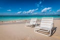 Two white beach chairs on Seven Mile Beach in Grand Cayman, Cayman Islands. Royalty Free Stock Photo