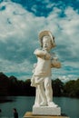 A beautiful white sculpture stands on the shore of the lake.