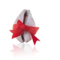 Beautiful white seashell tied with a red ribbon with a bow on a white background. Gift, shopping and holiday concept.