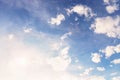 Beautiful white small soft fluffy clouds on a pale blue sky background. Sky with sun glare Royalty Free Stock Photo