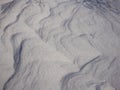 Beautiful white snow texture, formed by the winter wind. Waves and Dunes Royalty Free Stock Photo