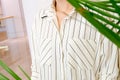 Beautiful white striped woman blouse shirt fashion details close up. minimal comfortable trendy fashion style.