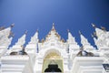 Beautiful white temple with clear blue sky background, Traditional Northern Thailand style temple