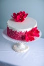 White Wedding Cake Decorated With Flowers Sugar Poppies And Red Pattern Ornament. Concept Of Elegant Holiday Desserts