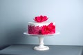 White Wedding Cake Decorated With Flowers Sugar Poppies And Red Pattern Ornament. Concept Of Elegant Holiday Desserts