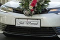 Beautiful white wedding car with plate JUST MARRIED Royalty Free Stock Photo