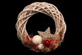Beautiful wicker christmas red white wreath on black background