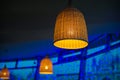 Beautiful wicker lamp on a blue background