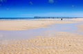 Beautiful wide open sandy beach over looking jetty pier