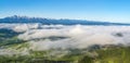 Beautiful wide panorama of the mountain range - Tatra Mountains. Morning fogs and clouds float above the valley. A wonderful
