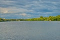 Beautiful wide river under a blue cloudy sky