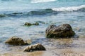 Beautiful wild beach landscape, sunny day, water waves hitting the cliffs, nature summertime scene, rocks, background Royalty Free Stock Photo