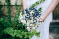 Beautiful wild flowers wedding bouquet in hands of the bride Royalty Free Stock Photo