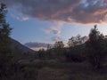 Beautiful wild Lapland nature landscape with birch tree forest and mountains. Sweden north landscape in summer, sunset  clouds Royalty Free Stock Photo