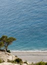 Beautiful wild Mediterranean pebble beach under a large cliff