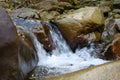 Beautiful little waterfall in mountains. Water flows between stones Royalty Free Stock Photo