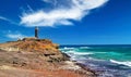 Beautiful wild rough coastal landscape, lighthouse on steep cliff, jagged rocks, ocean waves - Faro de Jandia, South Fuerteventura