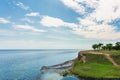 Beautiful wild sea beach covered with green grass Royalty Free Stock Photo