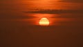 Beautiful wild sunrise and orange cloudy sky. The sun behind the clouds