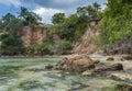 Beautiful wild tropical beach with rocks and palm trees Royalty Free Stock Photo